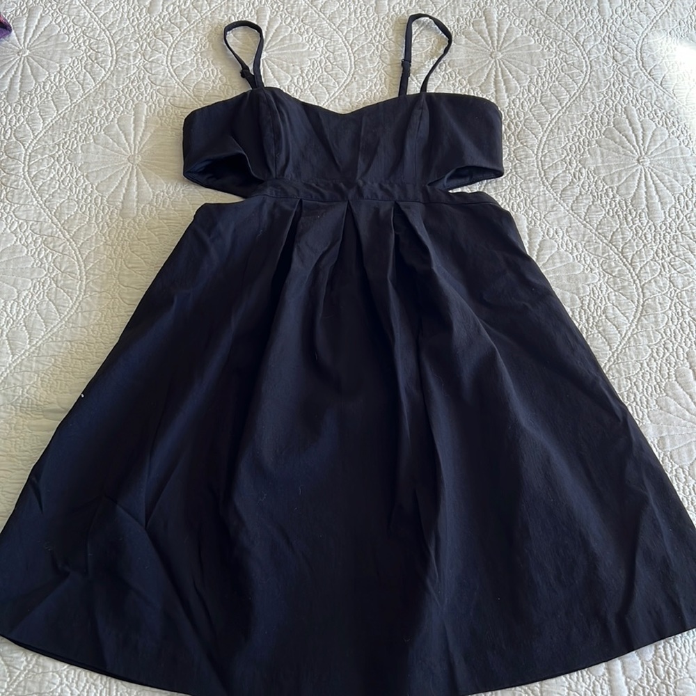 Short black open sides zippered dress.
